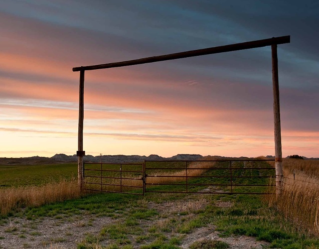 Sunset over ranch gate