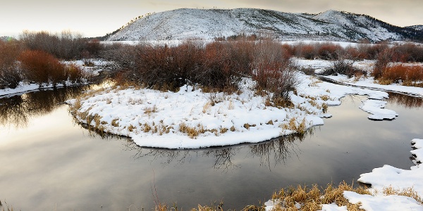 Snow covered hills and creek